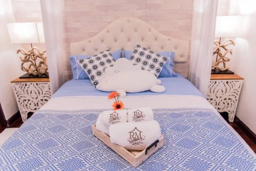 a bed with blue and white bedding and two lamps at Ruanmata Homestay in Chiang Mai