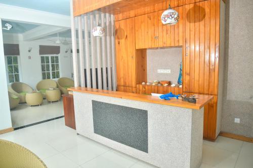 a living room with a tv and a mirror at La Cabana, Maamigili in Maamigili