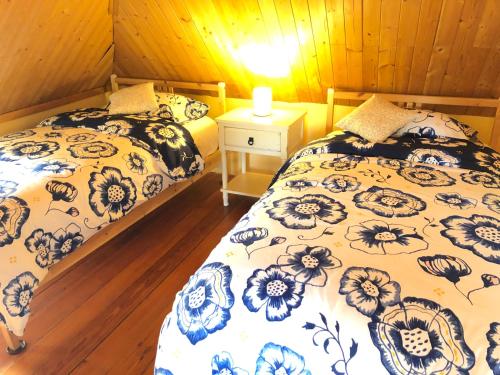 a bedroom with two beds and a table with a lamp at The Lodge Dog and Family Friendly 5 Bedrooms 13 guests 10 beds in Saint Peter