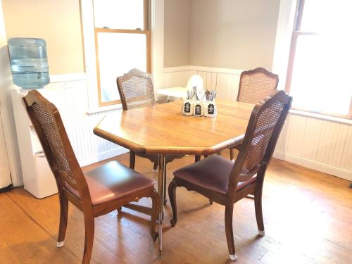 a dining room table with chairs and a wooden table at The Lodge Dog and Family Friendly 5 Bedrooms 13 guests 10 beds in Saint Peter