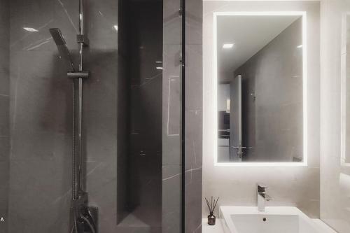 a bathroom with a shower and a sink and a mirror at Dusit D2 Huahin - In the heart of Hua Hin, Walk to the beach in 6 minutes 400m, Free WiFi in Hua Hin