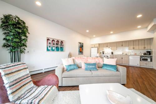 a living room with a couch and a table at Steamy Romantic Greek Corneer Suite King U/G Wifi in Edmonton