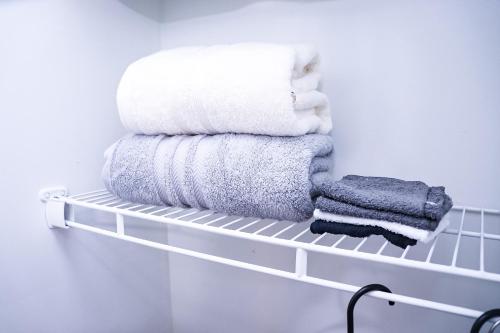 a pile of towels on a shelf in a bathroom at Luxury 2BR 1bt Suite basement Vacation House Private Entrance in Lithonia