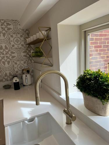 a kitchen sink with a faucet next to a window at 21 Pound Street in Petworth