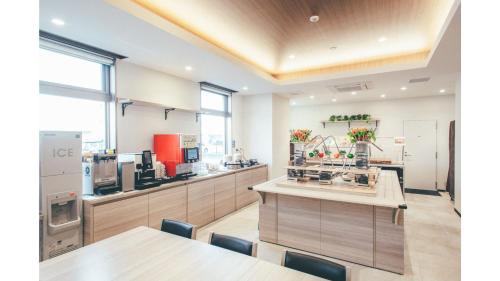 a kitchen with a table and a counter top at Kuretake Inn Premium Shizuoka Annex in Shizuoka