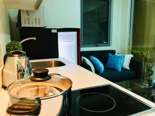a kitchen counter with a pot on a stove top at Acqua Private Residence Livingstone Tower Condo Unit with Free Wifi in Manila