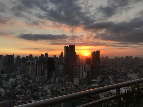 a view of a city skyline at sunset at Acqua Private Residence Livingstone Tower Condo Unit with Free Wifi in Manila