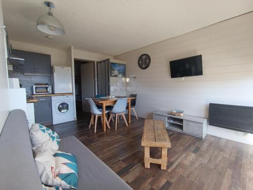 a living room with a couch and a table at auris en oisans, vue sur le massif des ecrins in Auris