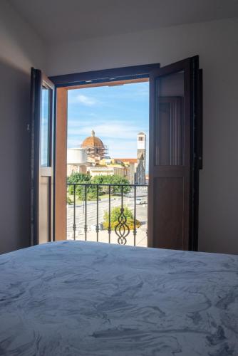 a bedroom with a door open to a balcony at West Sardinia Apartment 2 in Càbras