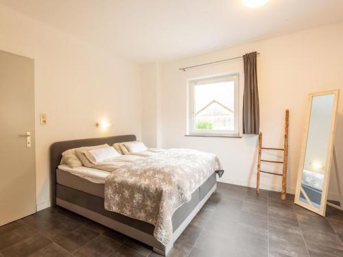 a bedroom with a large bed and a window at Apartment in Bichlbach near Ski Slopes in Bichlbach