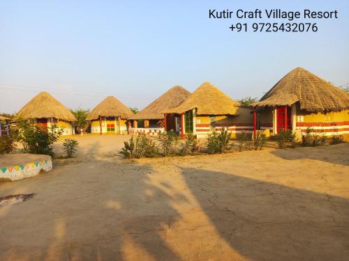 a row of huts with thatched roofs in a village at Kutir Craft Village Resort in Bherandiāla