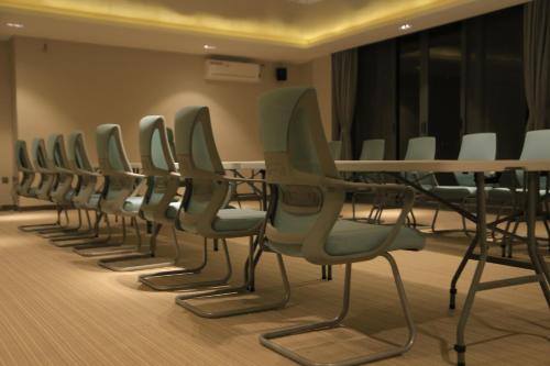 a row of chairs and tables in a room at Zara Garden Hotel and Apartments in Kampala