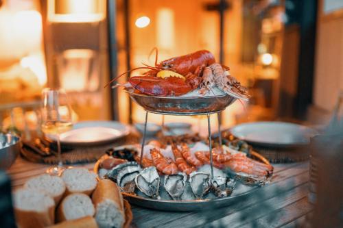 a plate of food on a table with lobster and other foods at Comme chez Soye - Private Wellness in Soye