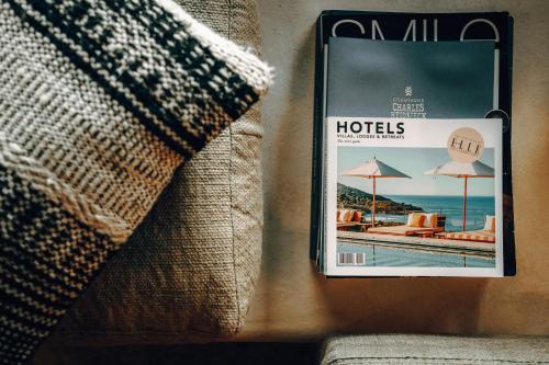 a magazine on a wall next to a couch at Comme chez Soye - Private Wellness in Soye