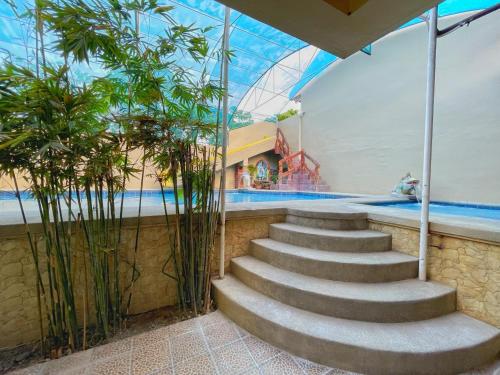 a set of stairs leading to a swimming pool at Weekdays Hotspring Resort by Cocotel in Calamba