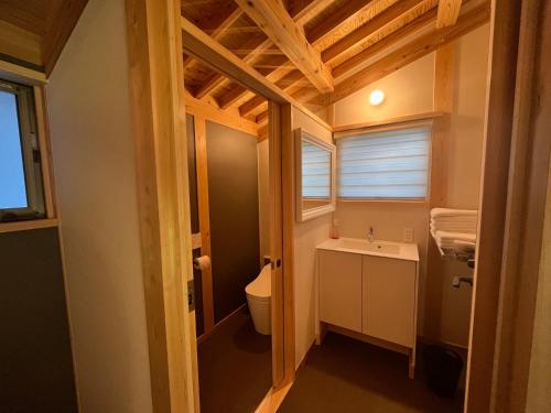 a bathroom with a toilet and a sink at CrossFit Otoyo Strength TINY HOUSE in Otoyocho