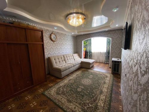 uma sala de estar com um sofá e um tapete grande em Quiet appartment in Bishkek city em Bishkek