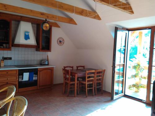 een keuken en eetkamer met een tafel en stoelen bij Apartmán na farmě u koní in Milešov