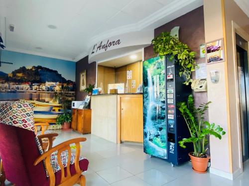 a restaurant with a drink machine in a room at Hostal L'Anfora in Denia