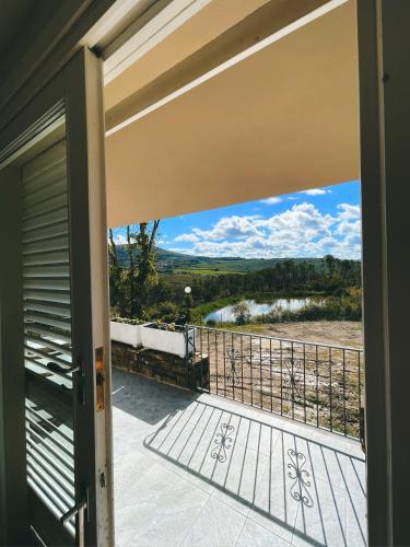 a door to a balcony with a view at Casa di Palaia in Strada