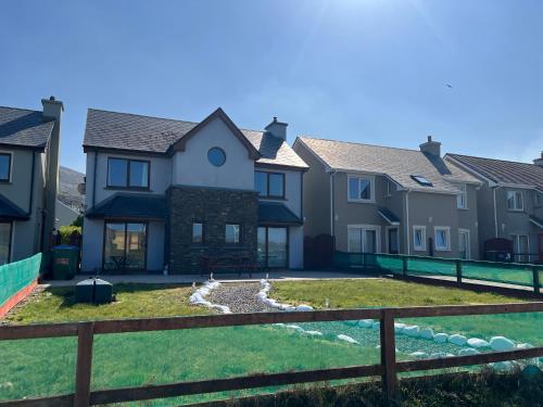 a row of houses with a fence at Picturesque Riverside Home in Cahersiveen