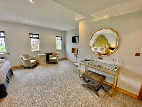 a room with a bed and a mirror on the wall at Sneaton Castle in Whitby