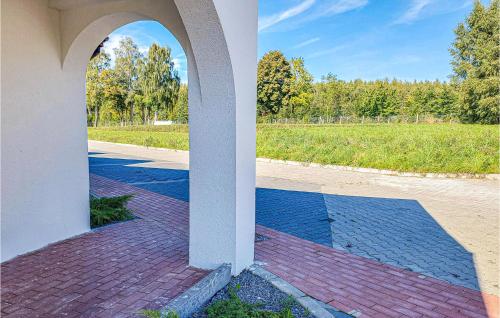 an archway of a building with a view of a field at Lovely Home In Slowienkowo in Skrzeszewo