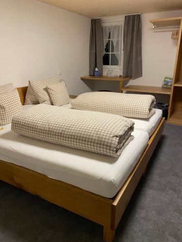 two twin beds in a room with at Hotel Landgasthaus Neues Bild, Eggerstanden in Appenzell