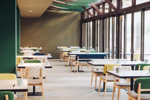 an empty dining room with tables and chairs at Chu Resort Hualien in Fenglin
