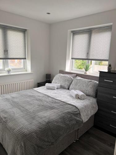 a bedroom with a bed with two towels on it at Pinfold Court Apartments in Knowsley