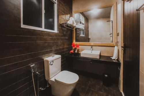 a bathroom with a toilet and a sink at The Niche Hikkaduwa - 10 minutes to the beach in Hikkaduwa
