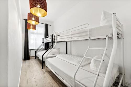 a room with two bunk beds and a window at Sweet Central Tiny Apartment for 4 People in Berlin