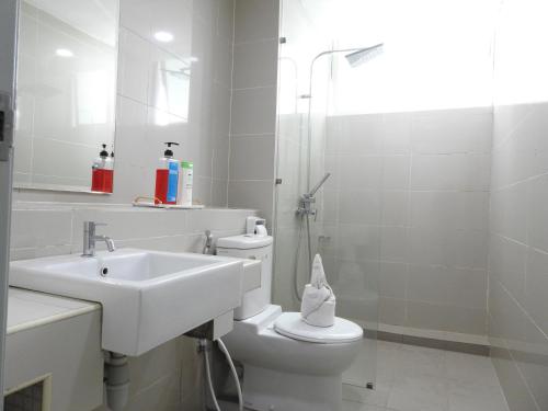 a white bathroom with a sink and a toilet at Superb Avengers Theme 舒沛复仇联盟主题 Sutera Avenue 2 Bedroom in Kota Kinabalu