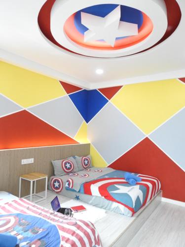 a bedroom with a colorful wall with a captain america mural at Superb Avengers Theme 舒沛复仇联盟主题 Sutera Avenue 2 Bedroom in Kota Kinabalu