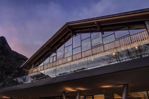 a building with large glass windows at dusk at Grand Hotel Courmayeur Mont Blanc, by R Collection Hotels in Courmayeur