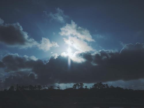 a cloudy sky with the sun in the sky at SOKI Kanazawa in Kanazawa