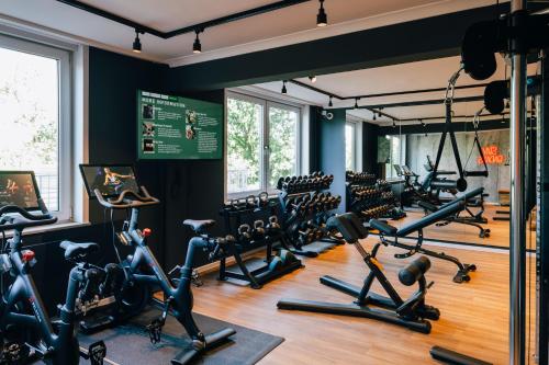 a gym with treadmills and elliptical machines at Pentahotel Bremen in Bremen