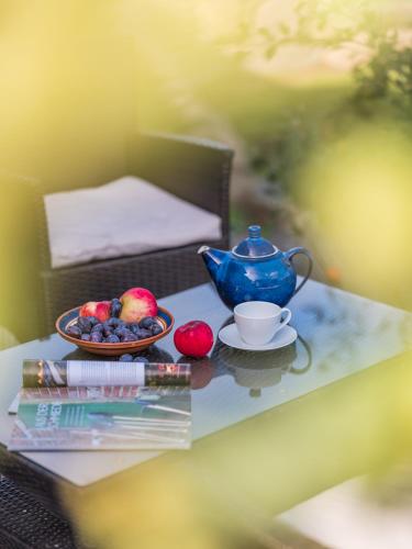 a table with a tea pot and fruit on it at Waldsiedlung No2 in Kröpelin
