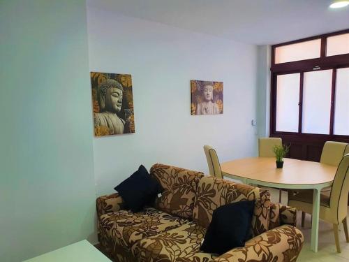a living room with a couch and a table at Stylish one bedroom apartment near the Drago Tree in Icod de los Vinos
