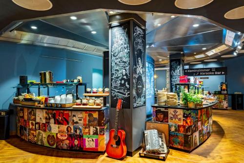 a store with a guitar on display at mightyTwice Hotel Dresden in Dresden