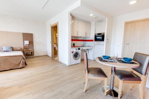 a living room with a bed and a table in a room at ZENAO Fréjus in Fréjus