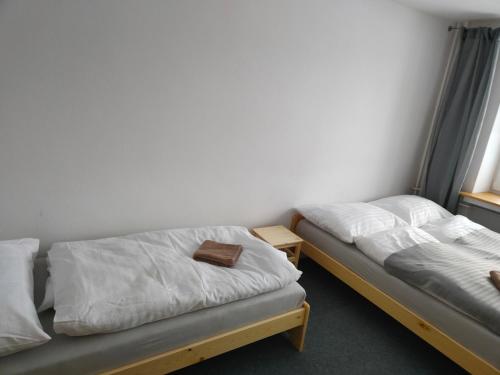 a room with two beds in a room at Chata - Dom Horskej služby Jasna in Demanovska Dolina