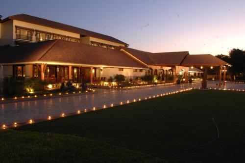 a building with lights in front of it at night at Madhubhan Resort & Spa in Anand