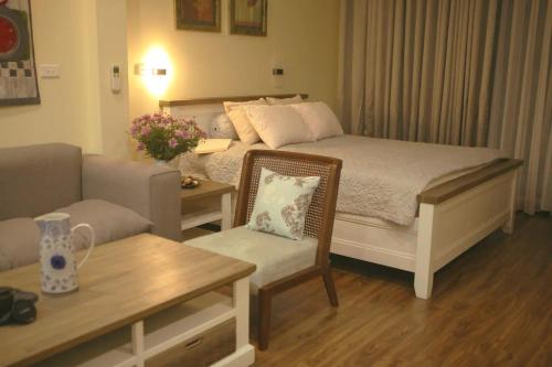 a living room with a bed and a couch at Auntie Liên's Homestay in Hanoi