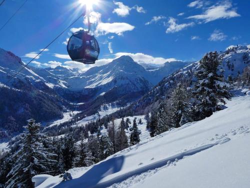 a ski lift in the air over a snow covered mountain at Chalet des Alpes NATURE & MOUNTAIN by Alpvision Résidences in Prarion