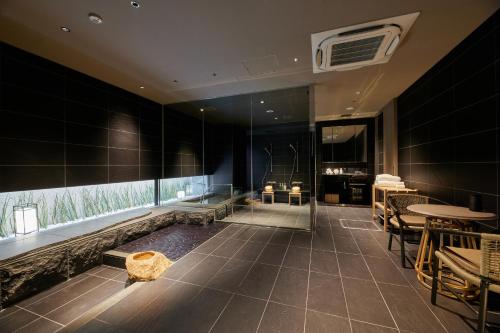 a bathroom with a tub and a table and chairs at THE HOTEL HIGASHIYAMA KYOTO TOKYU, A Pan Pacific Hotel in Kyoto