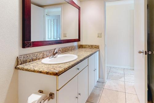 a bathroom with a sink and a mirror at Islander on the Beach 370 in Kapaa