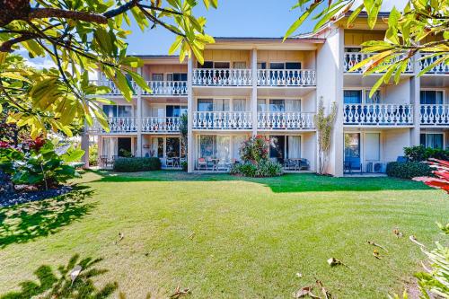 an exterior view of a building with a yard at Islander on the Beach 370 in Kapaa