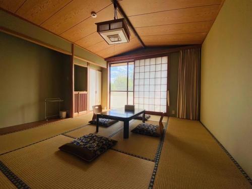 a room with a table and a large window at 地中海の家 in Futo