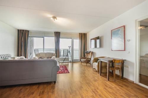 a living room with a couch and a table at Hello Zeeland - Appartement Port Scaldis 19-031 in Breskens